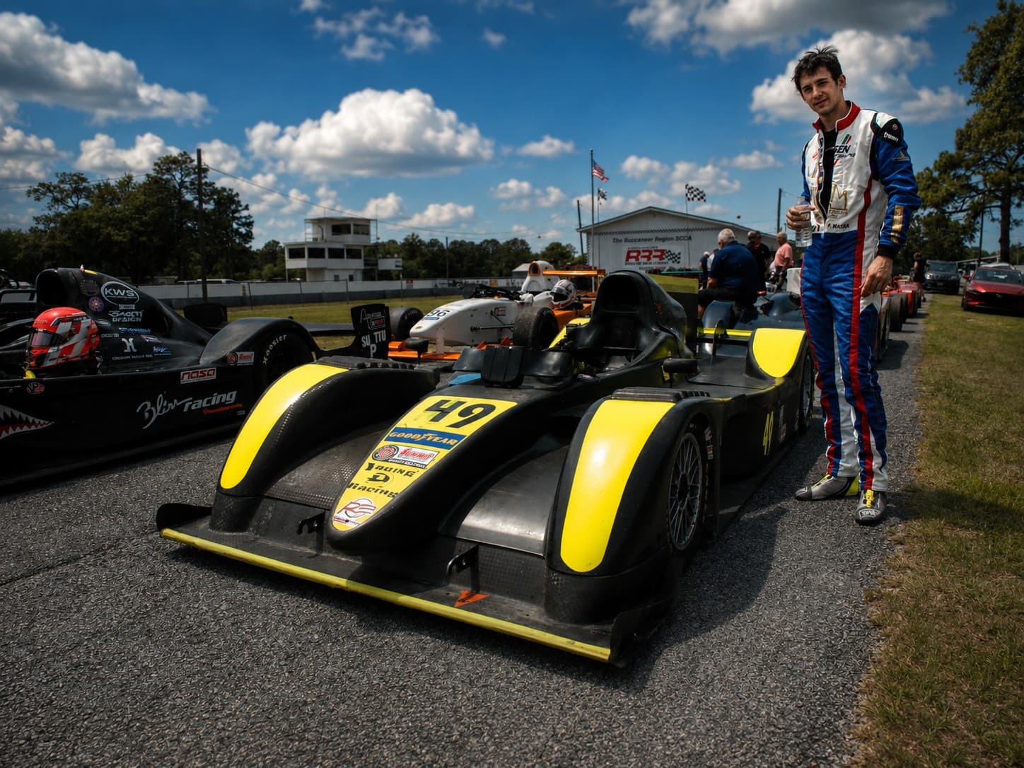 Filippo Massa standing beside race car number 49