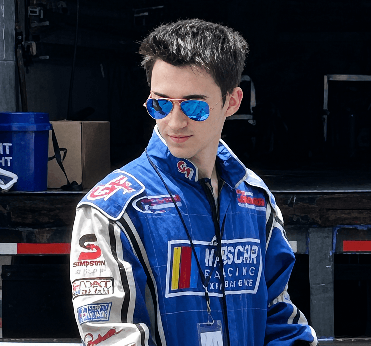 Filippo Massa in racing suit and sunglasses in the paddock