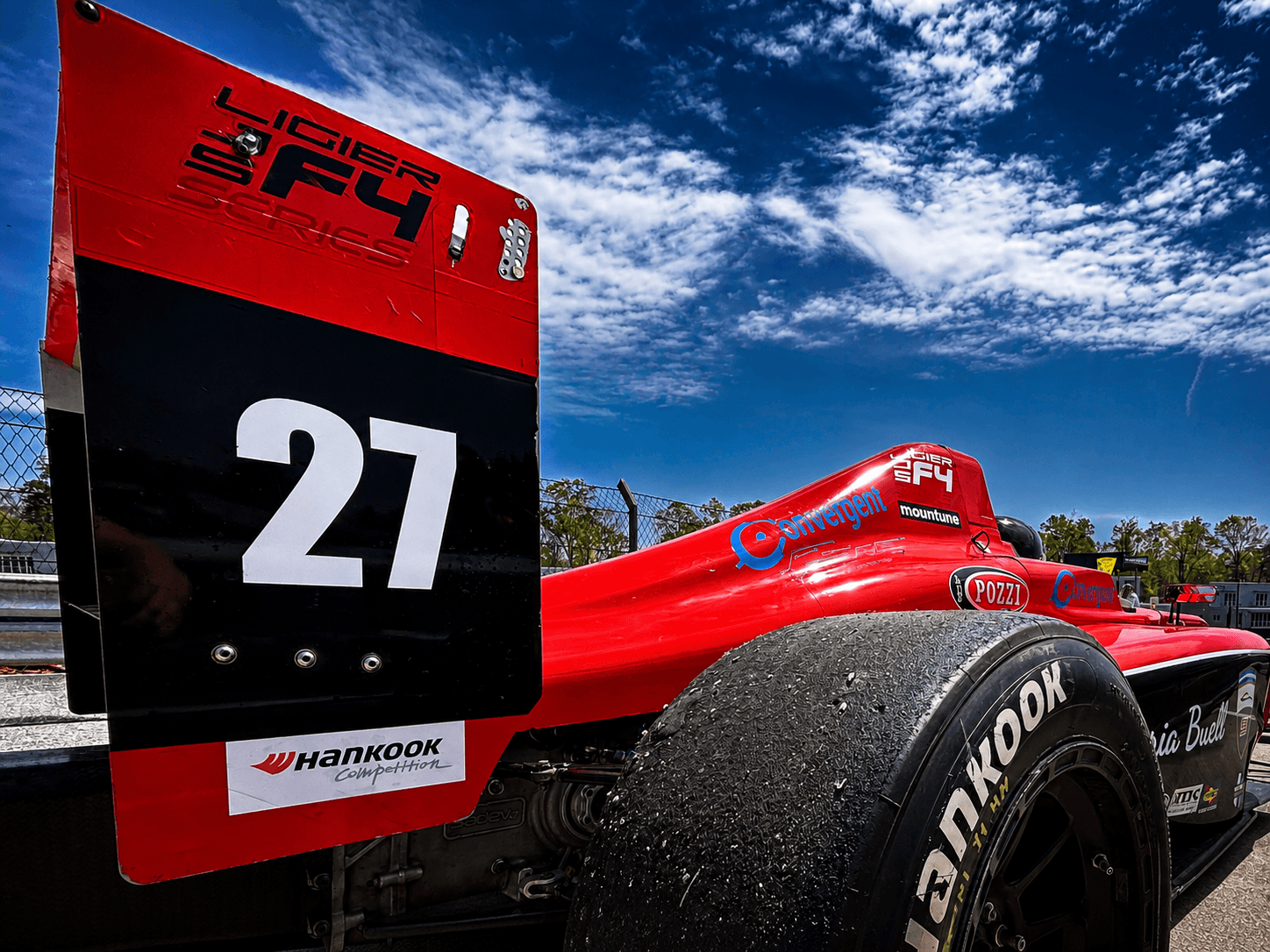 Rear view of red formula car number 27