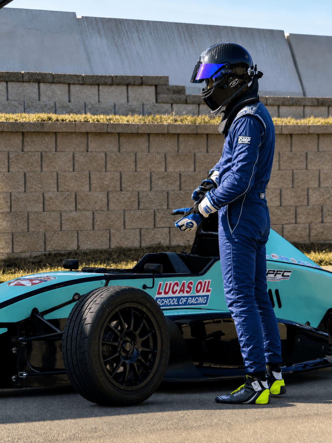 Filippo Massa standing beside open-wheel car number 70