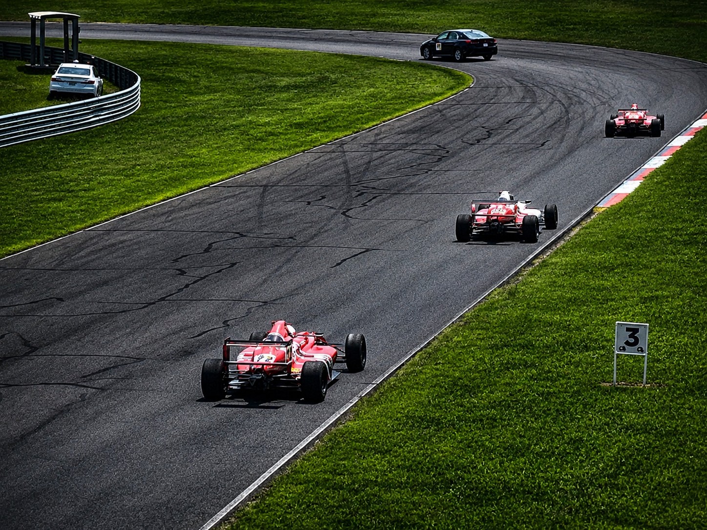 Multiple formula cars running on track