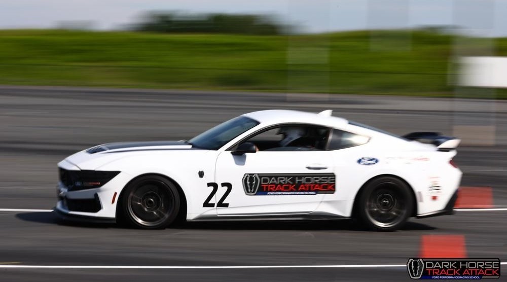 White Mustang Track Attack car in motion