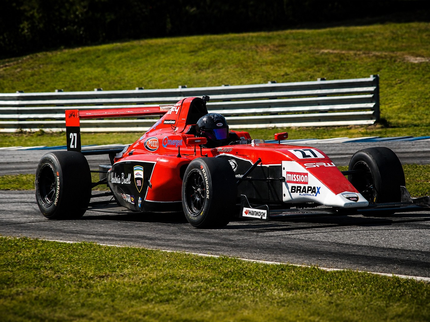 Red formula car number 27 on track