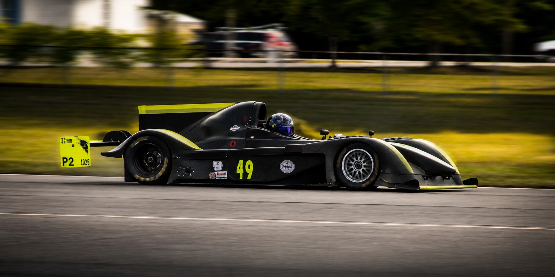 Black and yellow number 49 sports racer on track